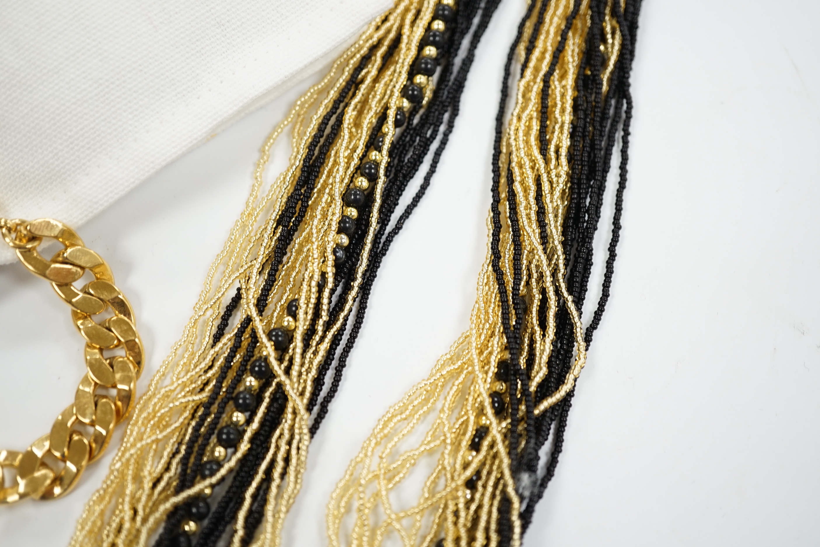 A Christian Dior Danseuse Etoile gilt bracelet, 18cm, with Dior box and pamphlet etc. together with a Luciani Murano glass bead twist necklace, 48cm.